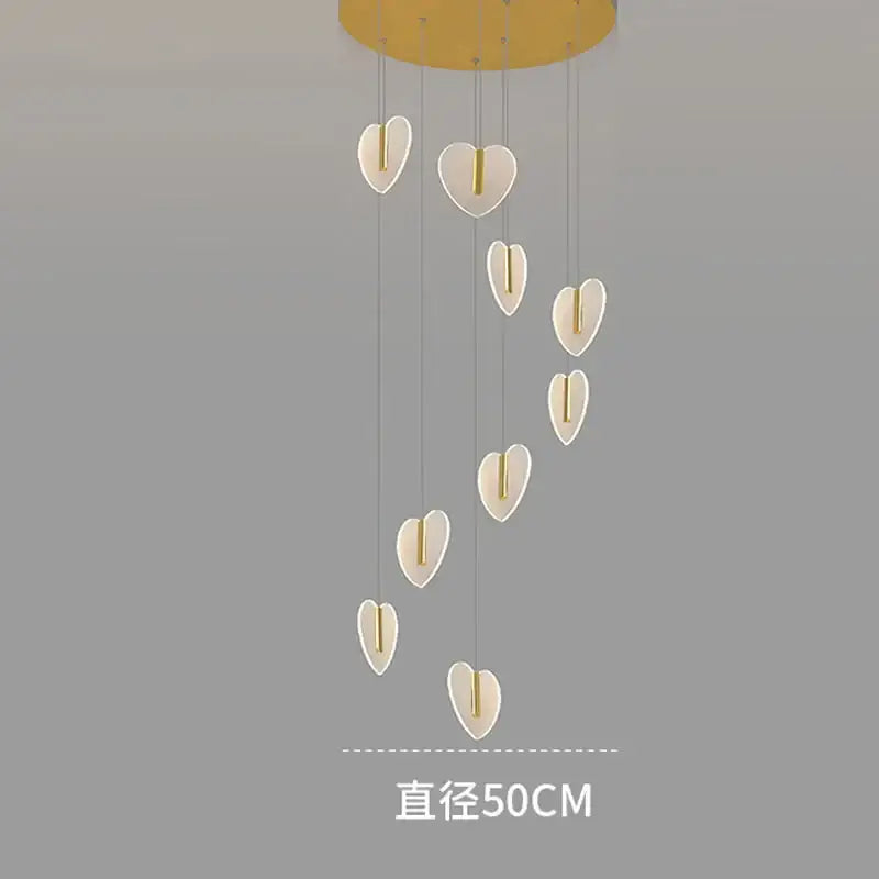 A modern decorbites love chandelier with white heart-shaped lights and gold crystal mount for staircase and living room
