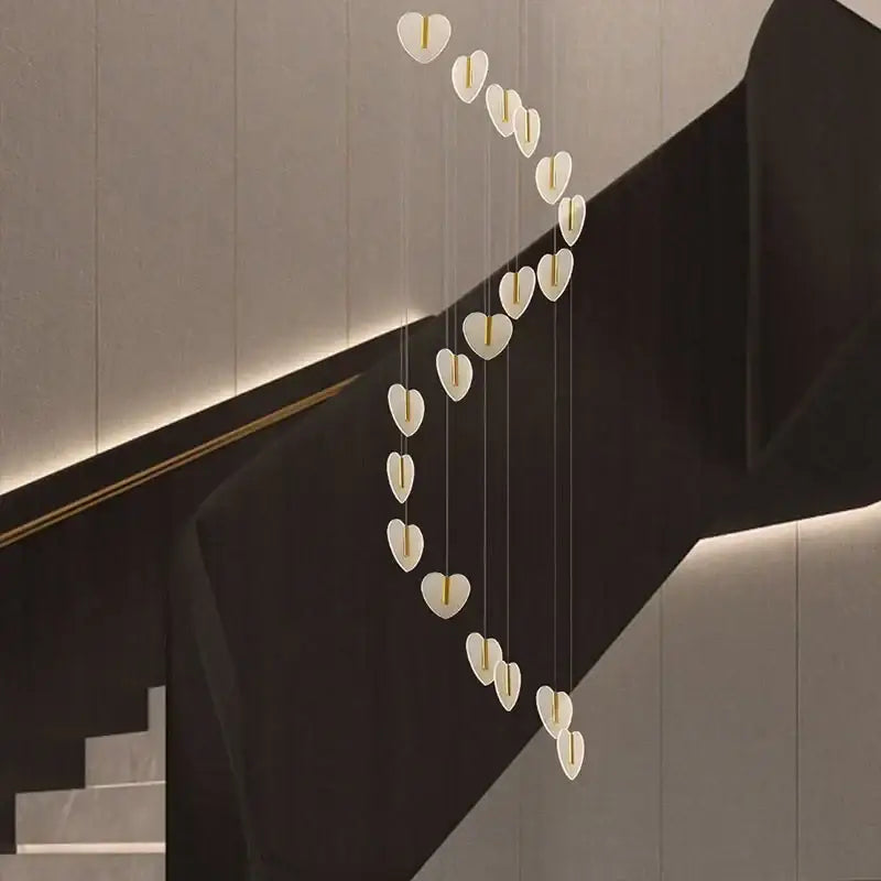 A modern decorbites love chandelier with white heart-shaped lamps and gold centers, ideal for staircase and living room lighting