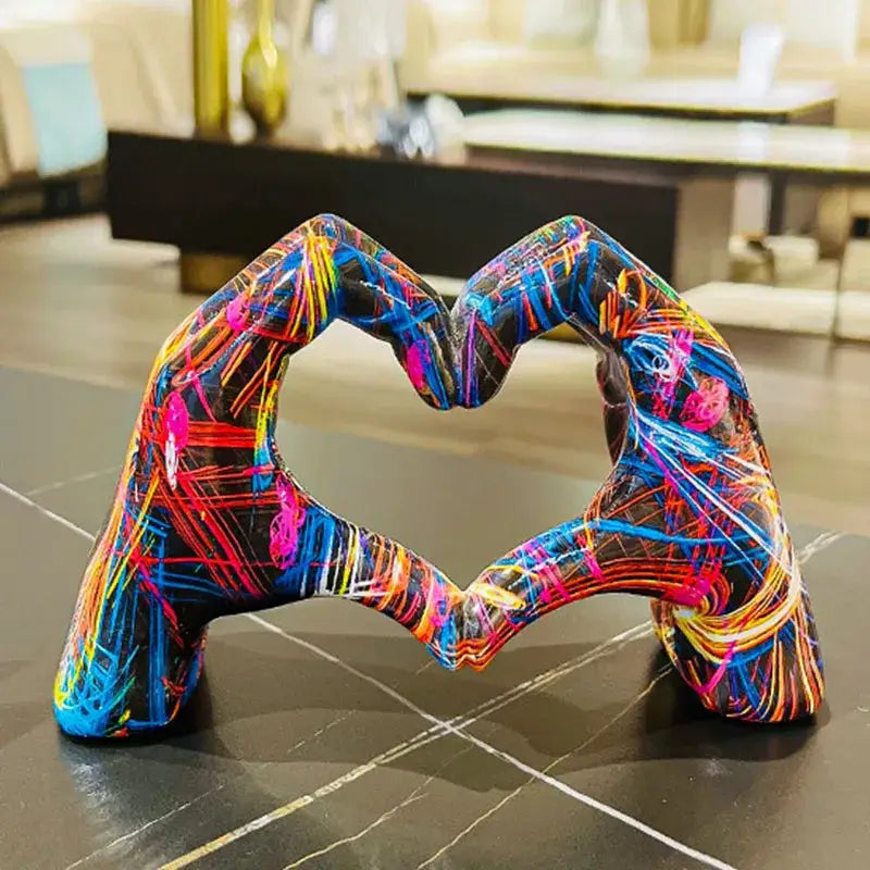 Vibrant abstractly painted resin love gesture sculptures of two hands forming a heart from decorbites heart hand pop art figurines