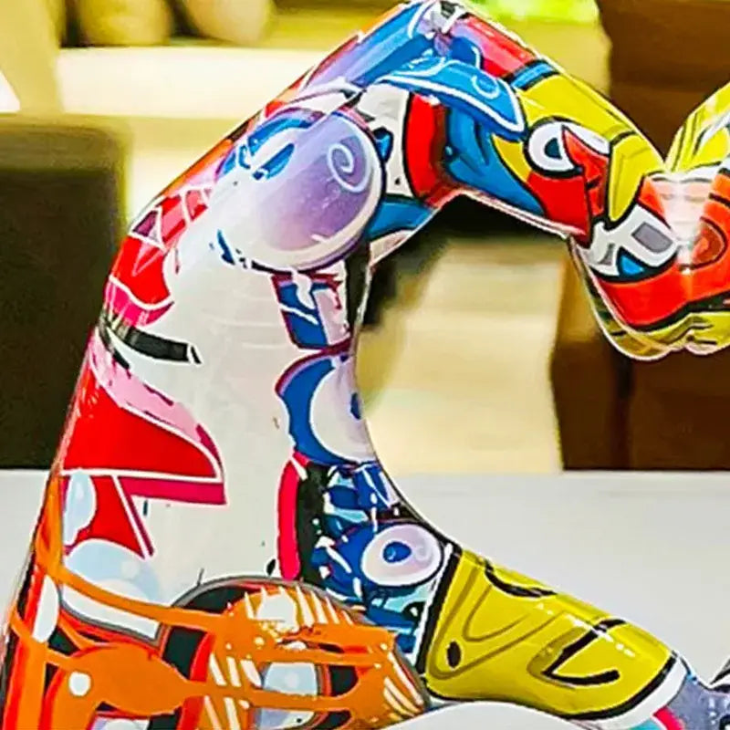 Vibrant DecorBites™ love gesture sculptures feature bold red blue yellow and orange abstract patterns on glossy white base