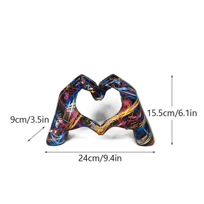 Vibrant abstractly painted resin love gesture sculptures by decorbites featuring two hands forming a heart shape