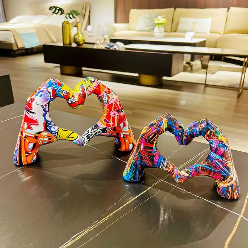 Vibrant love gesture sculptures featuring heart-shaped glossy resin with bold neon and pop-art colors by decorbites