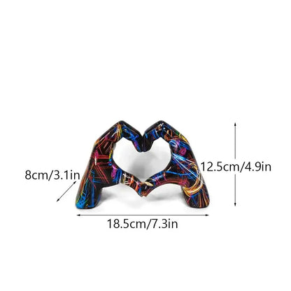Vibrant abstractly painted resin love gesture sculptures of two hands forming a heart shape by DecorBites™