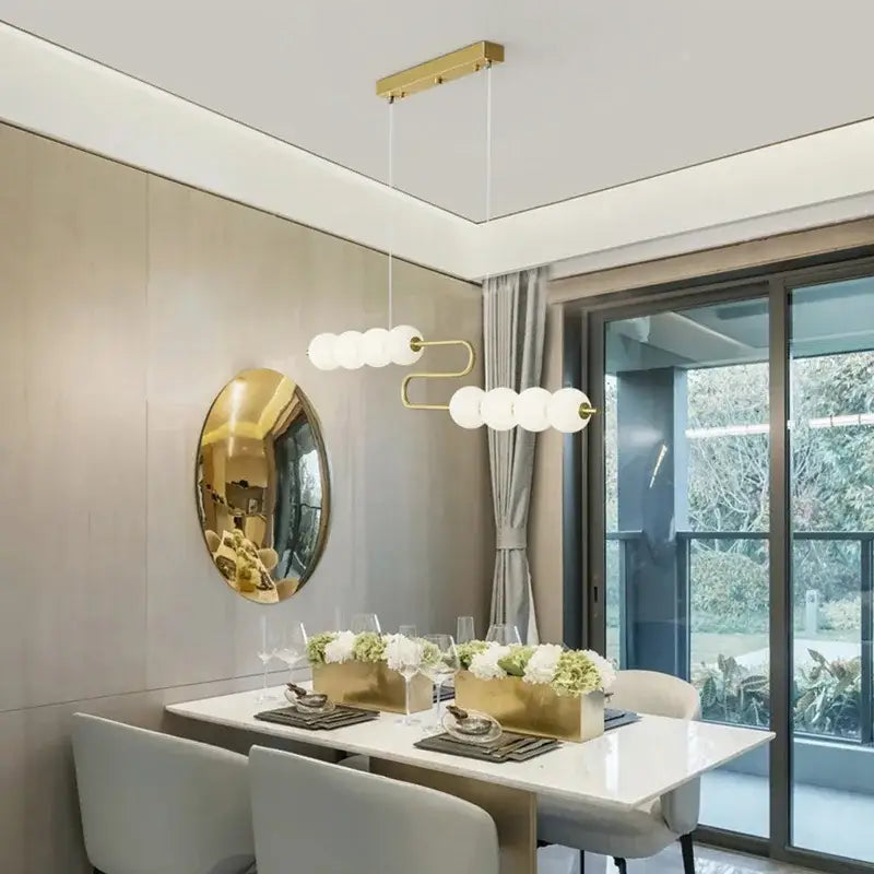 Gold-toned decorbites love gold chrome chandelier with curved metal frame and white glass bulbs for dining room lighting