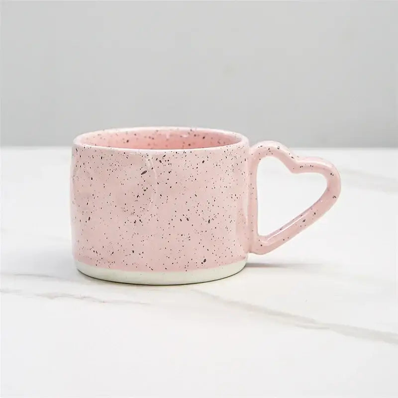 Pink speckled ceramic decorbites love handle cup with heart-shaped handle and white base for breakfast tea or coffee
