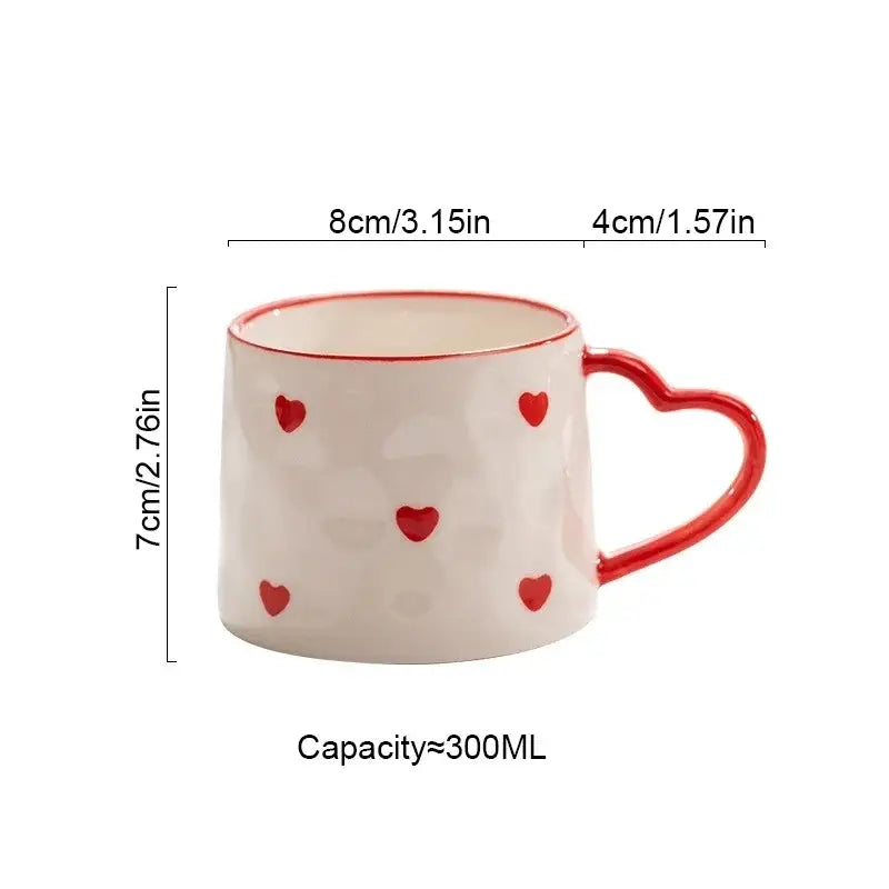 White ceramic mug with hand-painted red love heart ceramic handle and scattered decals by decorbites love heart