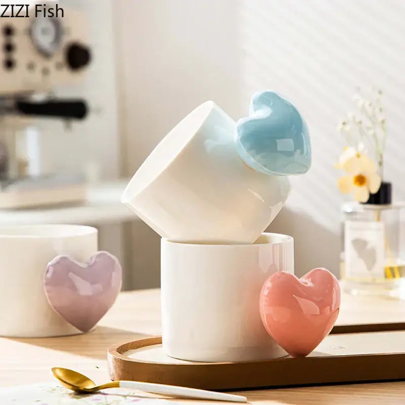 A set of white ceramic mugs with glossy pastel blue pink and lavender love heart ceramic accents for coffee tea and juice