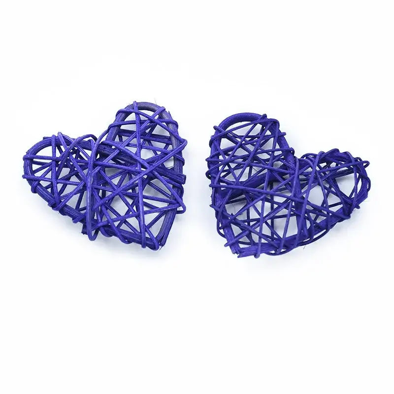 Two intricately woven purple heart-shaped love heart decorations made from natural twine by decorbites love heart