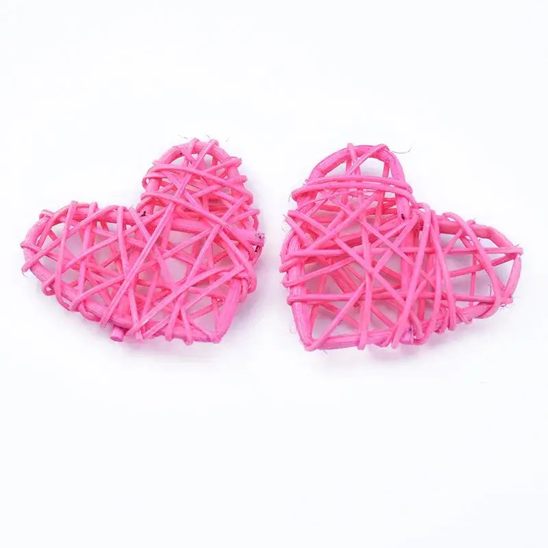 Two vibrant pink woven rattan love heart decorations by DecorBites perfect for wedding and valentines decor