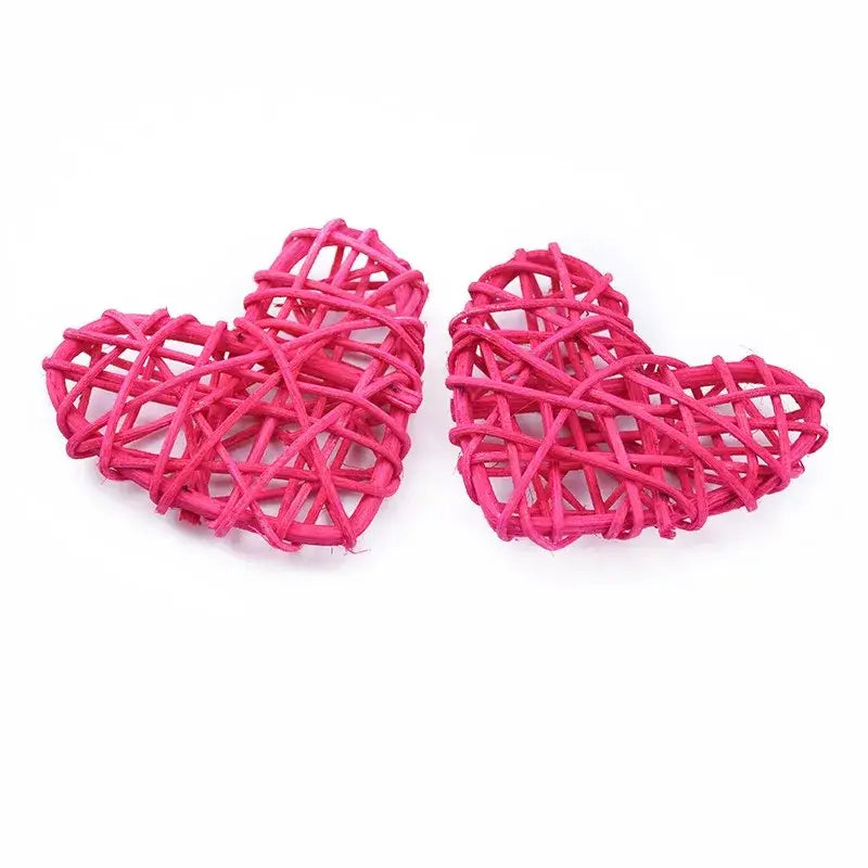 Two vibrant pink woven rattan love heart decorations by DecorBites love heart for wedding and Valentine use