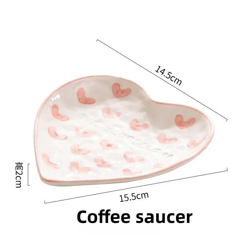 A white ceramic coffee saucer with decorbites love heart hand painted pink hearts and a glossy finish