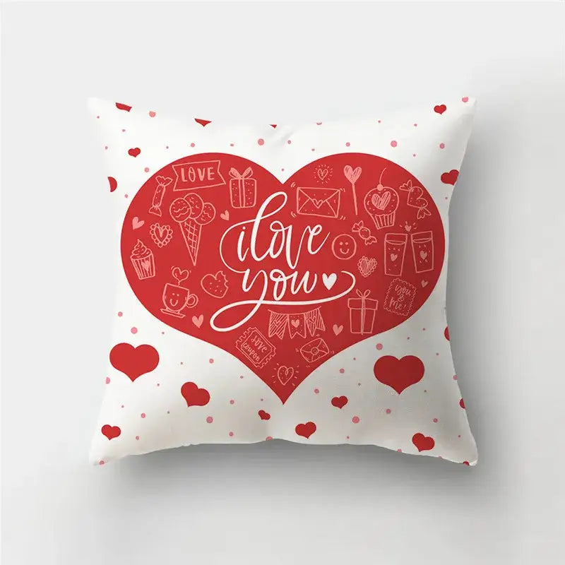 White throw pillow cover featuring a large red love heart print with cursive i love you and candy doodles for home decor
