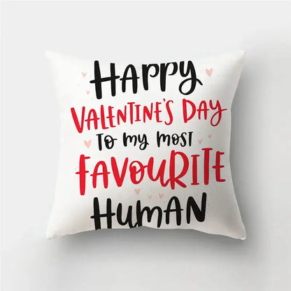 White throw pillow cover with love heart print and happy valentines day message accentuated by pink hearts