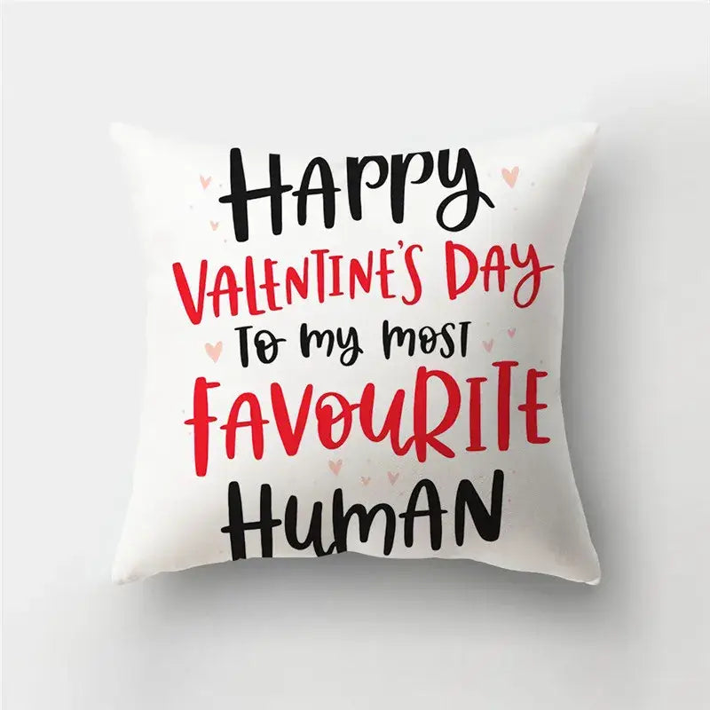 White throw pillow cover with love heart print and happy valentines day message accentuated by pink hearts
