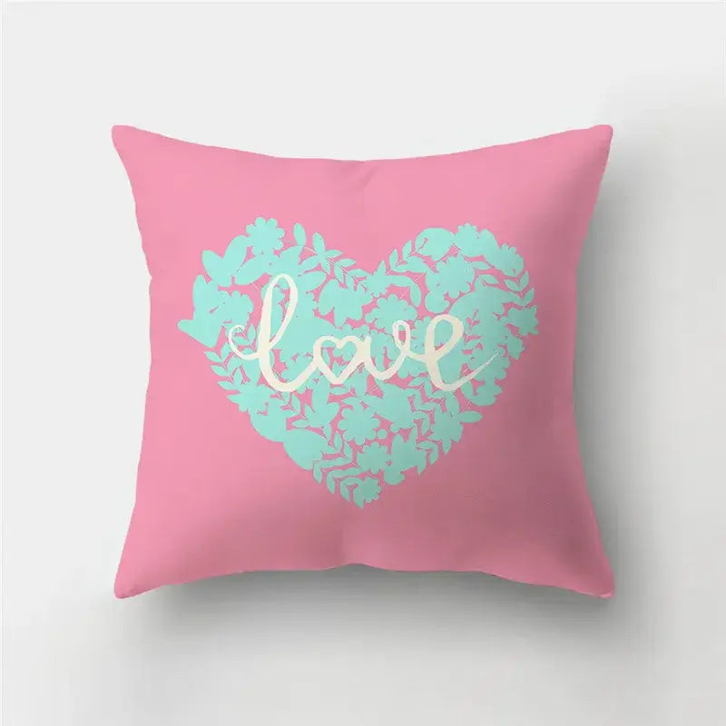 Pink throw pillow with mint green floral love heart print and white cursive love for cushion covers and sofa decor
