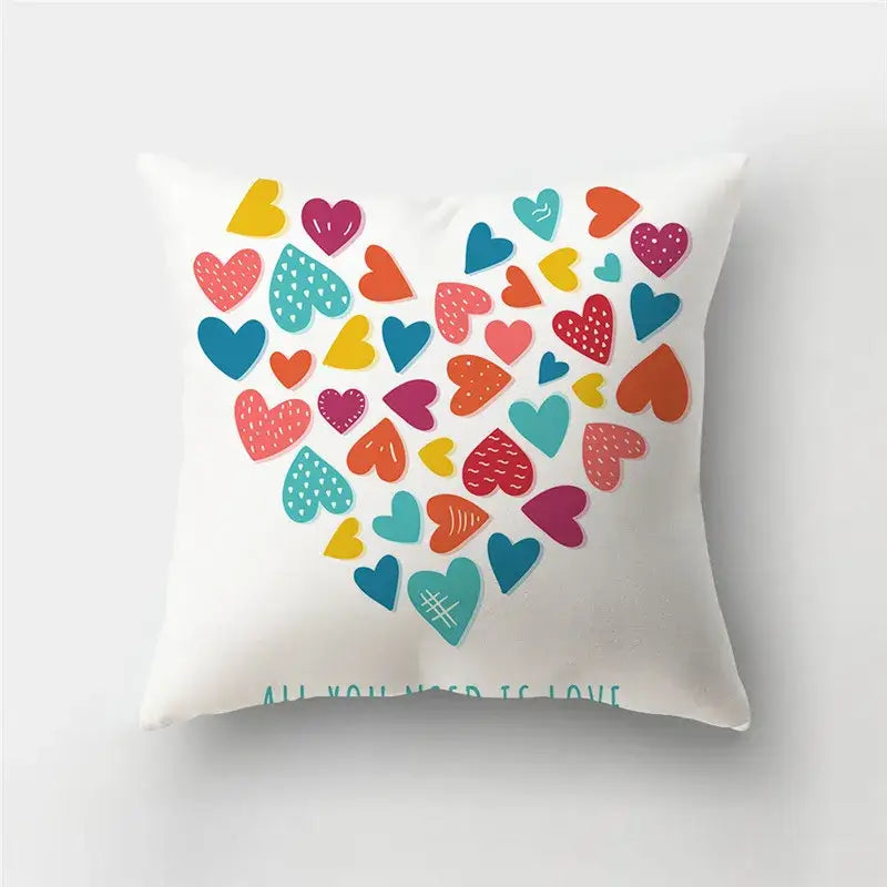 White throw pillow with colorful vibrant love heart print featuring assorted pink blue yellow orange and teal hearts cushion covers