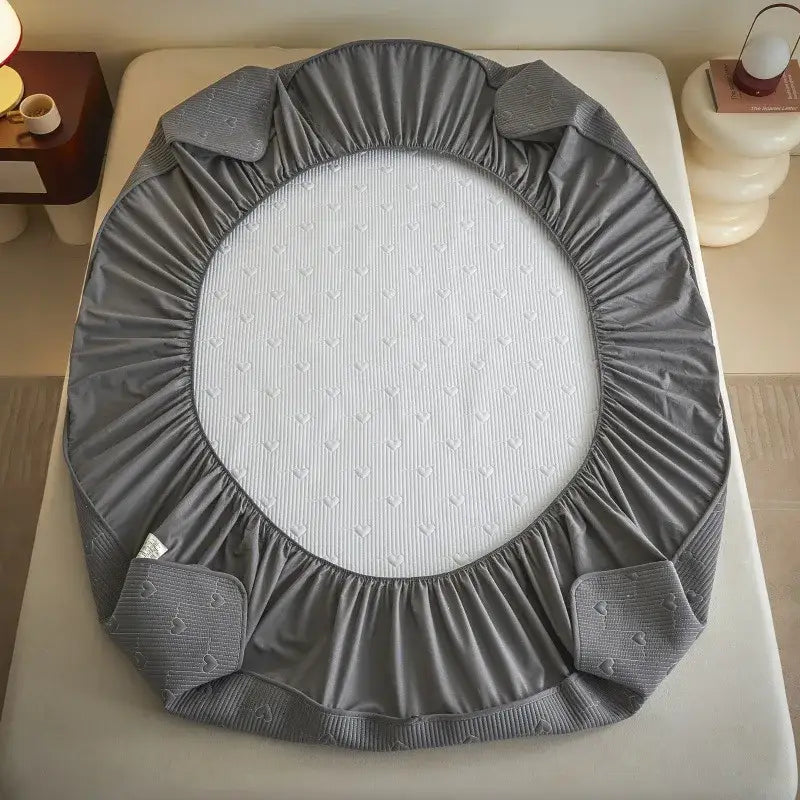 Gray elastic fitted sheet with white textured lining and heart-patterned corners from decorbites love pattern cotton collection