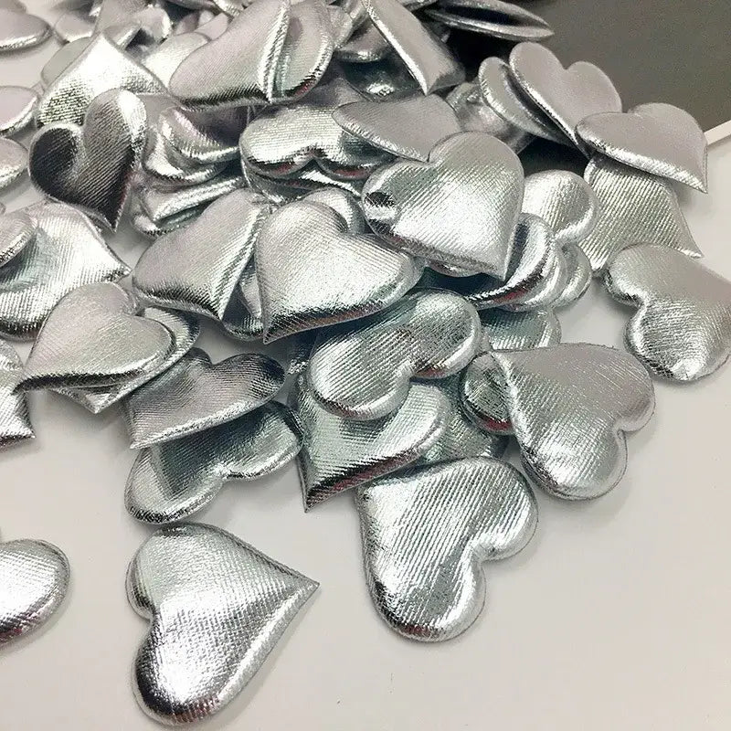 Shiny silver heart-shaped confetti with textured fabric surface from decorbites love petal peach heart wedding bouquet