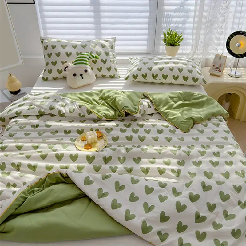 A cozy white and sage green heart-patterned decorbites love print soft summer quilt with satin-like lining