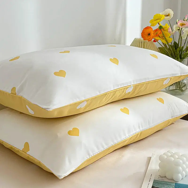 White pillowcases with yellow heart patterns and mustard-yellow trim in decorbites love printed pillowcase set