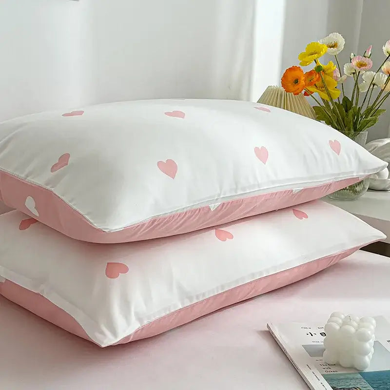 White pillowcases with pink heart patterns and matching pink inner linings from decorbites love printed pillowcase set