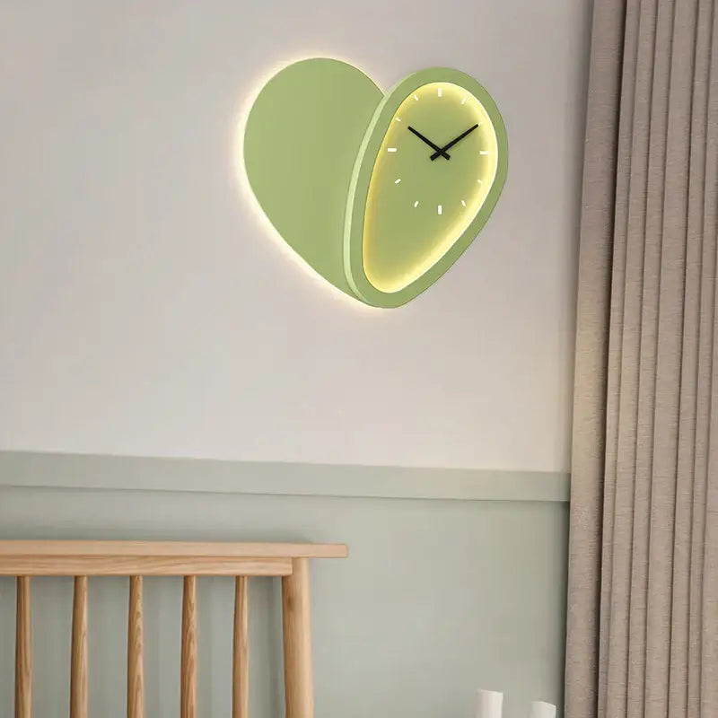A modern decorbites love shaped wall lamp clock with a mint green exterior and glowing yellow interior for indoor use