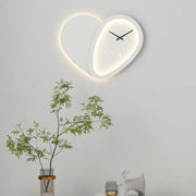 A modern white decorbites love shaped wall lamp with dimmable led light and minimalist black hands clock