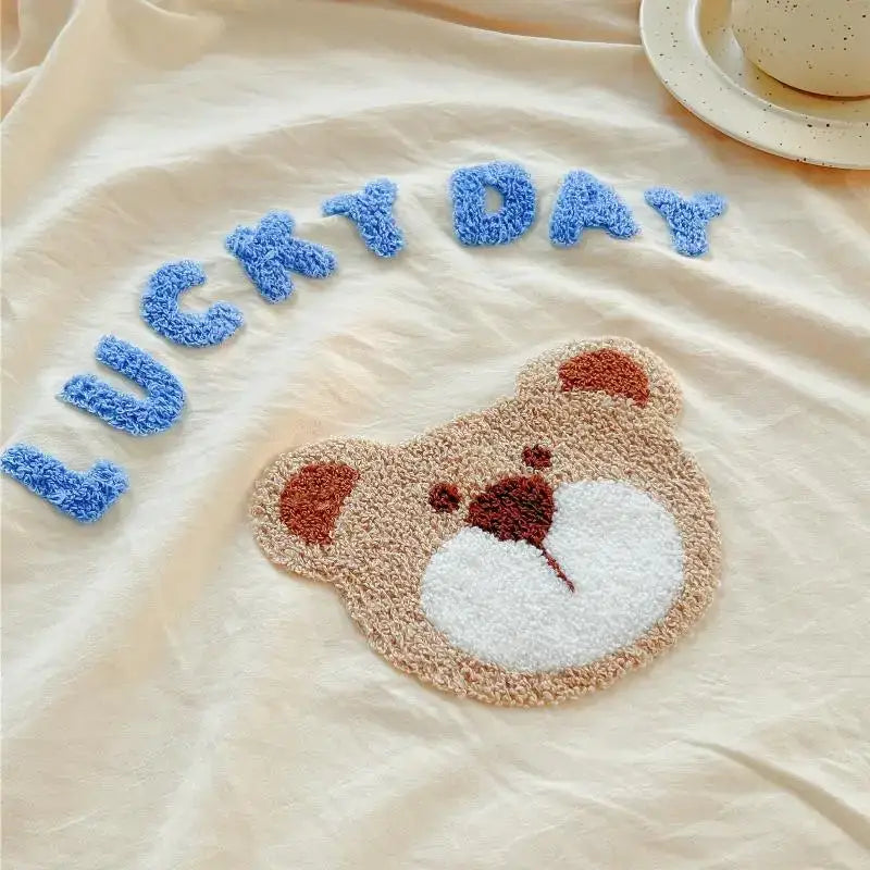 Decorbites lovely bear and sheep embroidered bedding set with plush beige teddy bear face rug and blue lucky day lettering