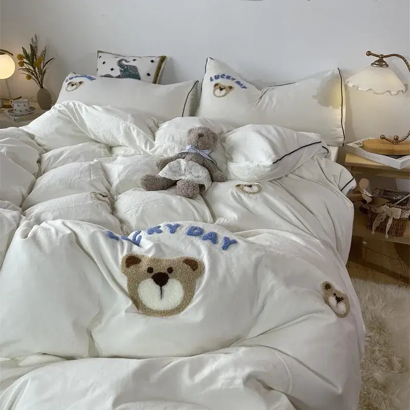 Decorbites white plush teddy bear pillow sham with blue lucky day text and brown bear face in embroidered bedding set