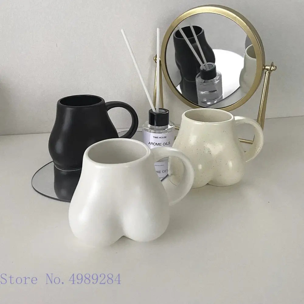 White ceramic coffee cup with playful butt shape design and glossy finish for decor and storage by decorbites