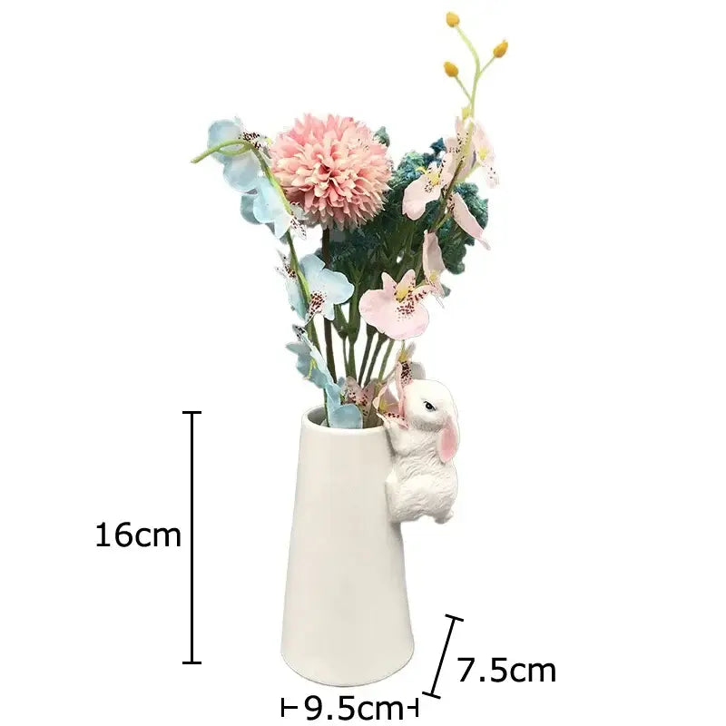 White ceramic vase with a decorbites lovely rabbit figurine and pastel floral arrangement for table decor