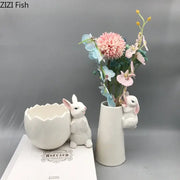 White ceramic vase shaped like a rabbit with a small bunny figurine peeking out decorbites lovely rabbit ceramic vase