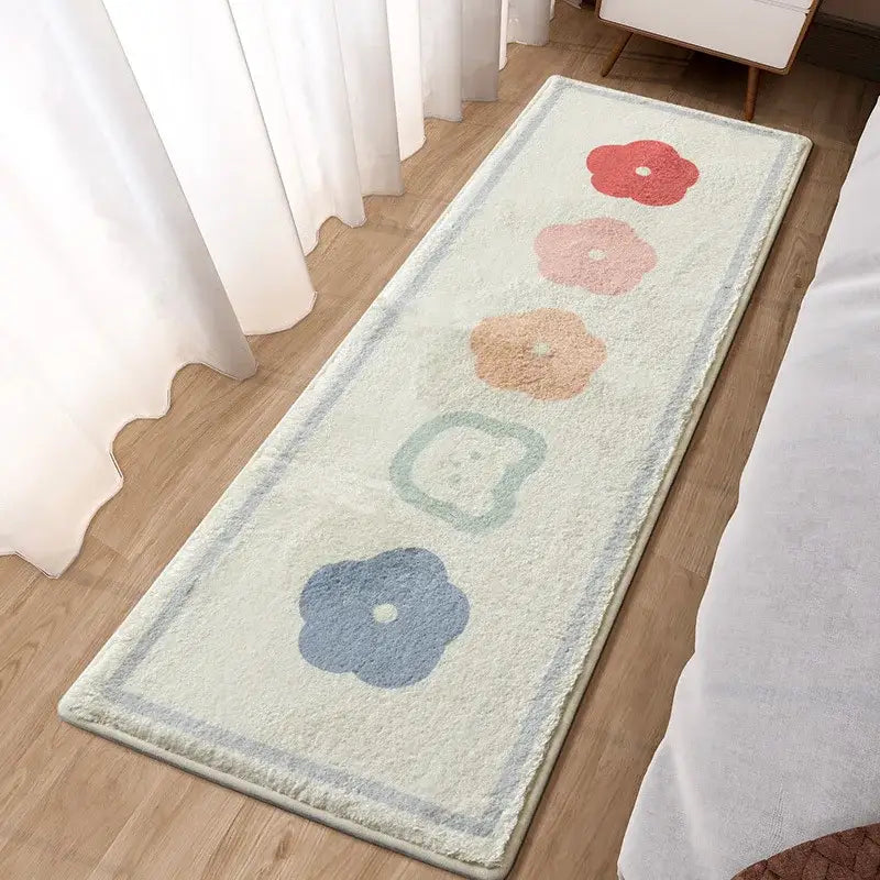 A soft cream-colored plush decorbites lovely rabbit pink bedside rug with blue piping and pastel flower designs for girls