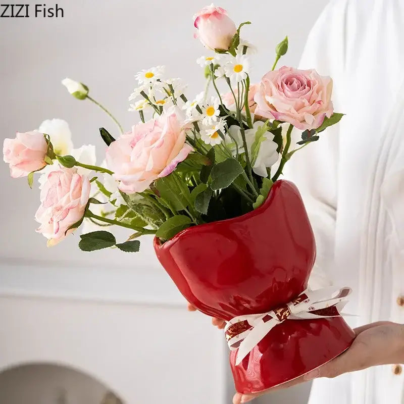 A glossy red ceramic vase shaped like a high-heeled shoe with a white ribbon bow from decorbites lovely ribbon vase set