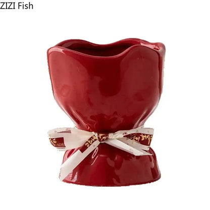 A glossy red ceramic planter vase from the decorbites lovely ribbon ceramic set with a white ribbon detail