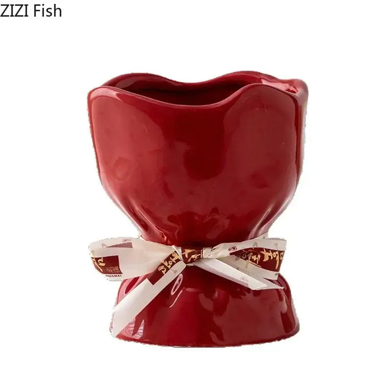 A glossy red ceramic planter vase from the decorbites lovely ribbon ceramic set with a white ribbon detail