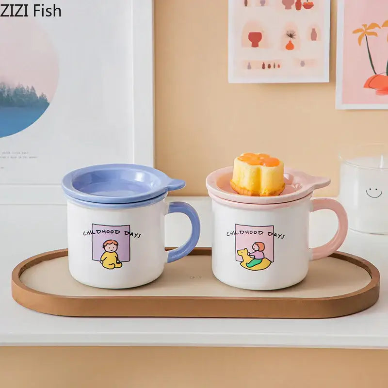 Two pastel-colored porcelain coffee mugs with matching lids featuring decorbites lovers cartoon pattern and handles in blue and pink