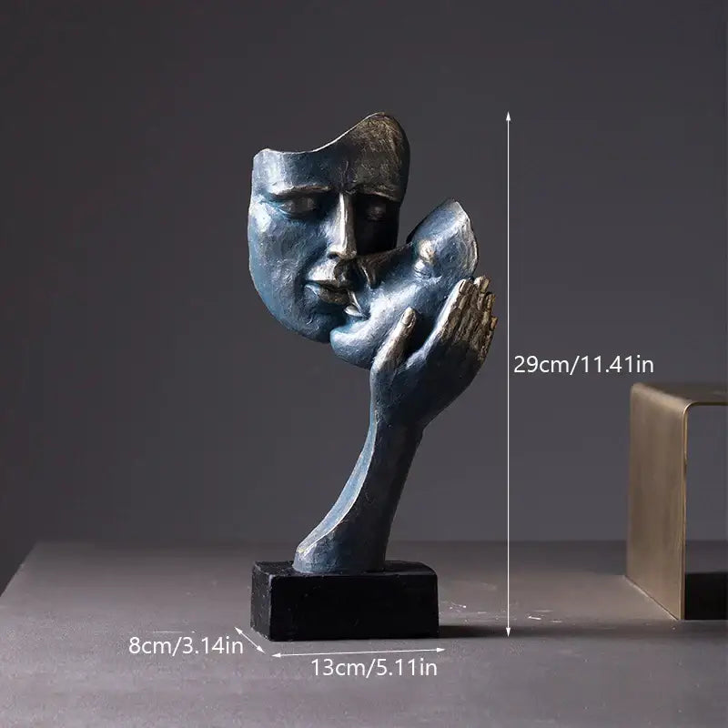 A sleek metallic decorbites loving couple resin statue featuring two abstract faces in a tender embrace on a black base