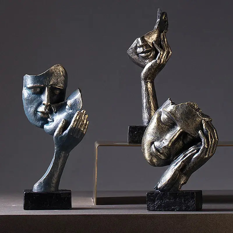 DecorBites loving couple resin statue features blue and gold metallic face sculptures held by hands for interior decor
