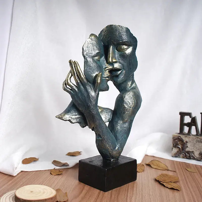 Abstract bronze-colored loving couple resin statue with two intertwined faces on black base by DecorBites loving couple