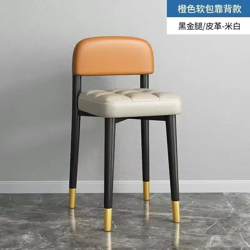 Decorbites low square stool bench with orange and off-white leather and gold-accented black legs for dining and kitchen use