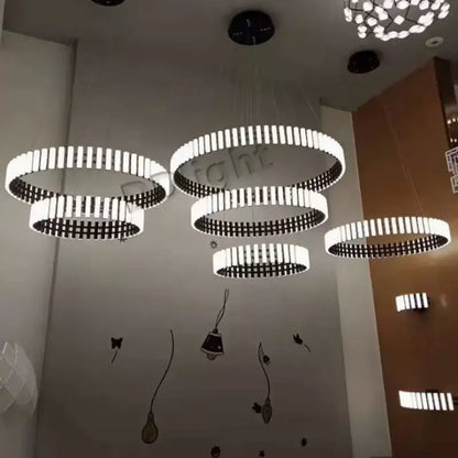 DecorBites Lstre modern circle chandelier features white and black circular pendant lights for bright 360° lighting