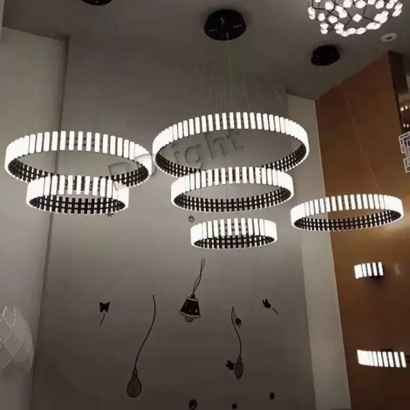 DecorBites Lstre modern circle chandelier features white and black circular pendant lights for bright 360° lighting