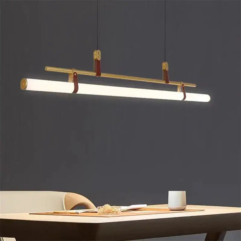 Modern minimalist decorbites lucien tube chandelier with white led tube, brass hardware, and black gold leather straps