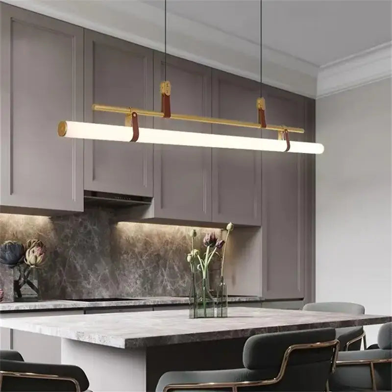 Modern gold-toned linear pendant light with leather straps in decorbites lucien tube chandelier black gold leather design