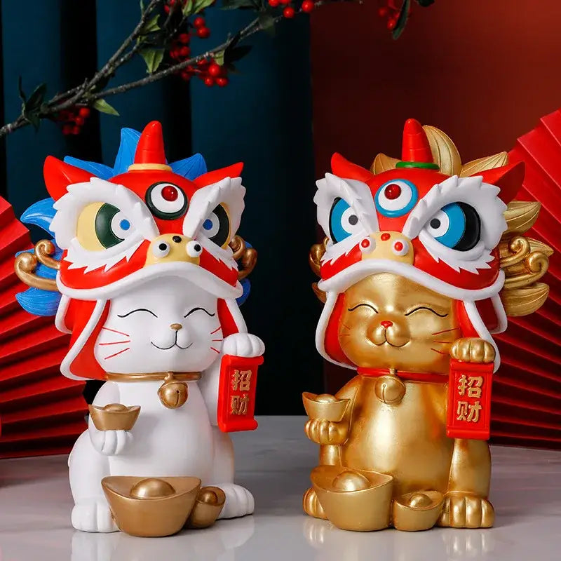 Two decorbites lucky cat resin figurines in white and gold with red lion dance masks and golden ingot for home decor