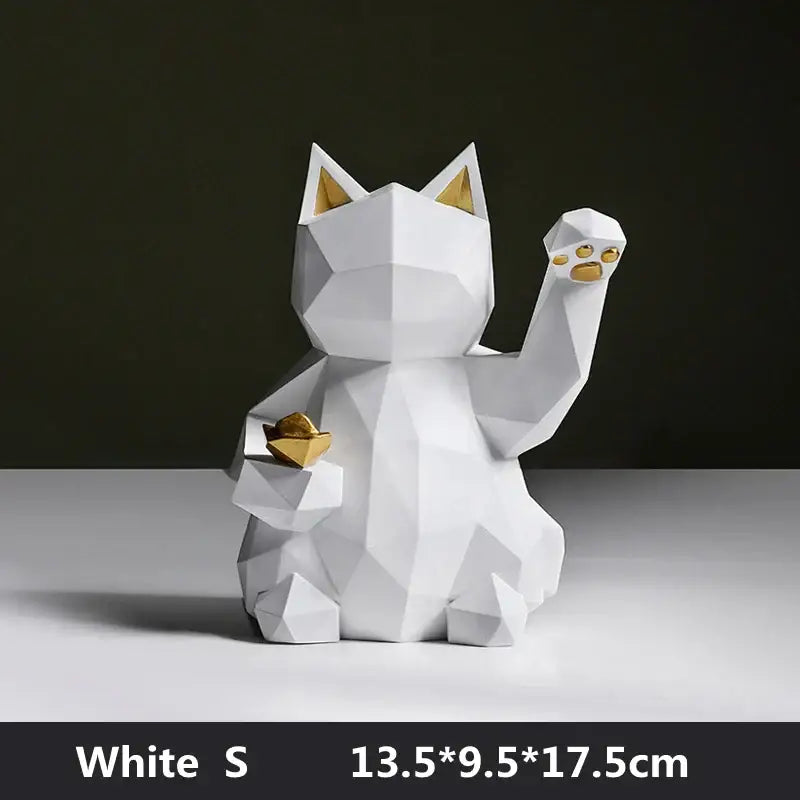 White geometric resin DecorBites lucky cat figurine with gold accents holding a paper boat for modern home decor