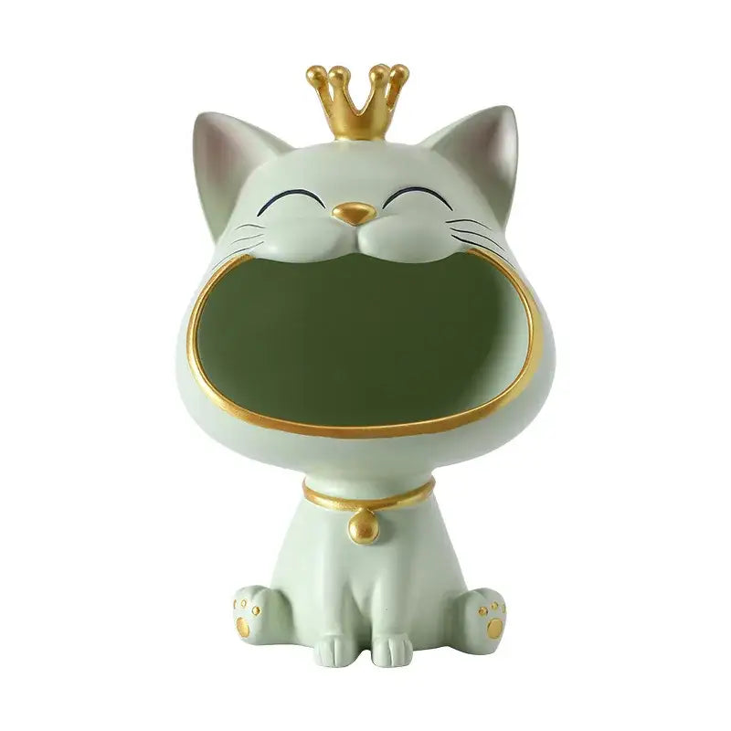 A mint green ceramic lucky cat sculpture with a gold crown and open mouth storage compartment by decorbites
