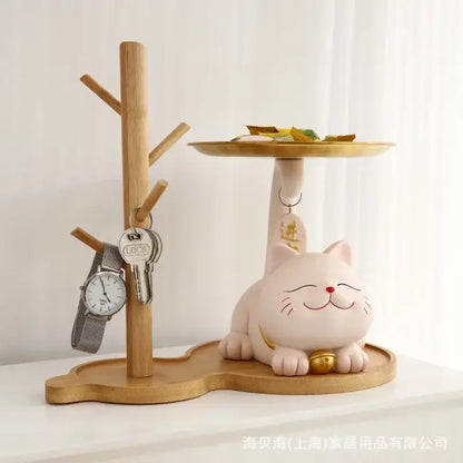 A charming pink ceramic decorbites lucky cat statue with a gold bell and red nose for home decor and storage