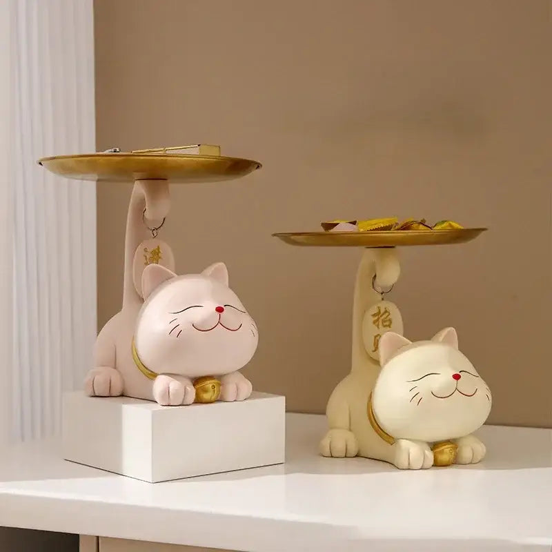 Two pink and cream-colored ceramic decorbites lucky cat statue ornaments with gold-trimmed trays for home decor and storage